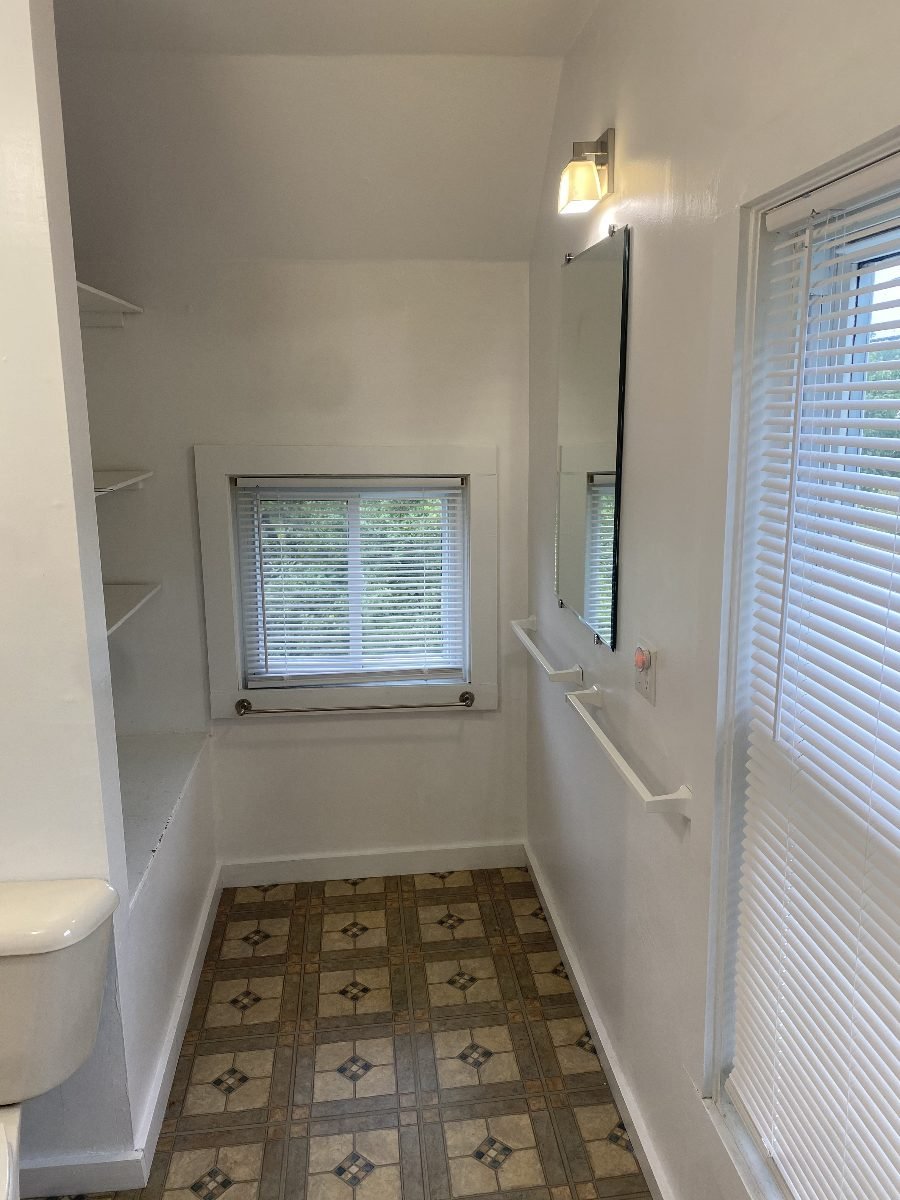 Full bath, window and linen shelving