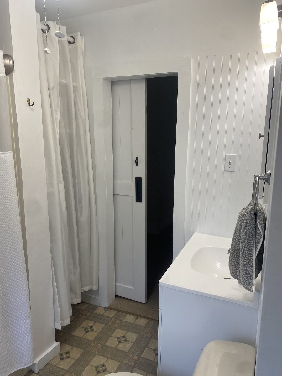 Full bath, tub and shower with pocket door