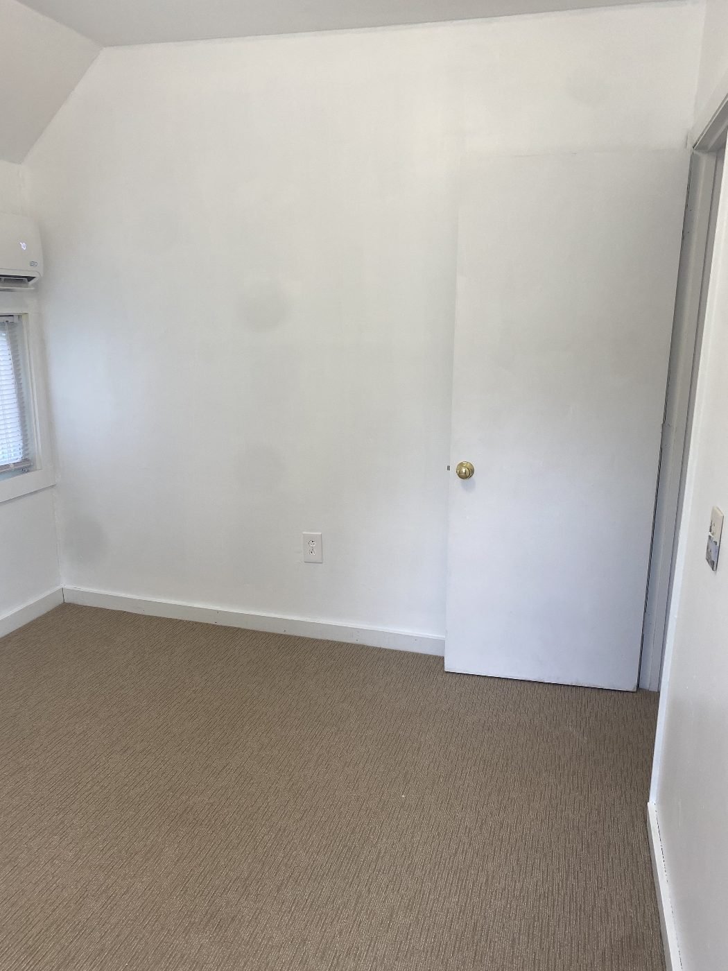 Third bedroom with mini-split and closet door