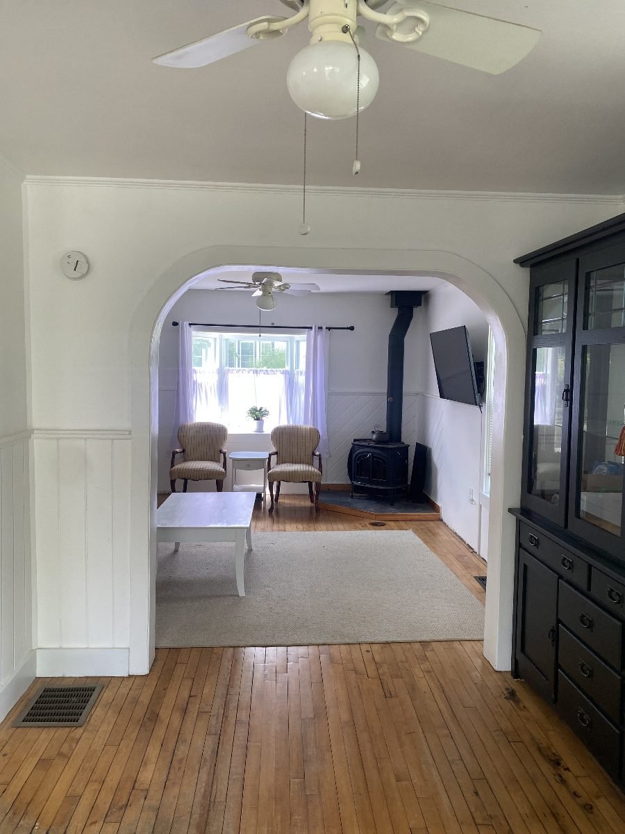 Dining room with arched opening to the living room