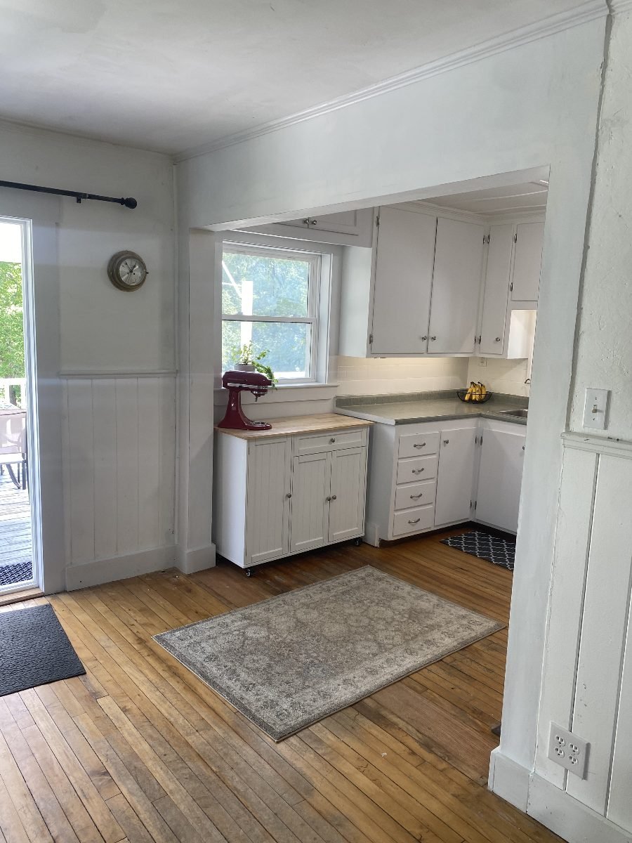 Dining room looking into the kitchen, deck door at left