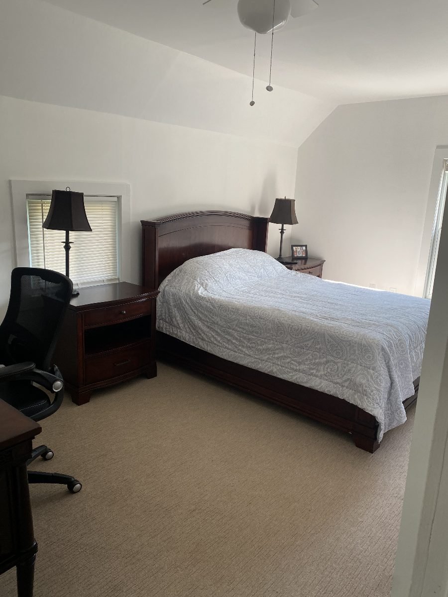 Primary bedroom with dresser and dressing area